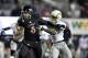 DEKALB, IL - NOVEMBER 26: Cornerback Ronald Zamort #7 of the Western Michigan Broncos (R) tries to tackle quarterback Jordan Lynch #6 of the Northern Illinois Huskies as he runs for a 37-yard touchdown during the third quarter at Huskie Stadium on Novemb