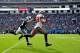 CHARLOTTE, NC - DECEMBER 01: Vincent Jackson #83 of the Tampa Bay Buccaneers runs a catch along the sideline as Drayton Florence #29 of the Carolina Panthers defends during play at Bank of America Stadium on December 1, 2013 in Charlotte, North Carolina.