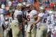 Nov 30, 2013; Gainesville, FL, USA; Florida State Seminoles quarterback Jameis Winston (5) smiles and celebrates with offensive linesman Tre' Jackson (54) and safety Philip Doumar (57) after they scored a touchdown against the Florida Gators during the se