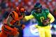 EUGENE, OR - NOVEMBER 29: Quarterback Marcus Mariota #8 of the Oregon Ducks is chased by Sean Martin #6 of the Oregon State Beavers during the 117th playing of the Civil War on November 29, 2013 at the Autzen Stadium in Eugene, Oregon. (Photo by Jonatha