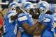Sep 29, 2013; Detroit, MI, USA; Detroit Lions running back Reggie Bush (21) receives congratulations from wide receiver Ryan Broyles (84) and running back Joique Bell (35) after scoring a touchdown in the second quarter against the Chicago Bears at Ford F