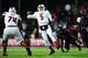 Dec 5, 2013; Cincinnati, OH, USA; Louisville Cardinals quarterback Teddy Bridgewater (5) scrambles out of the pocket and throws a pass for a touchdown during the fourth quarter against the Cincinnati Bearcats at Nippert Stadium. Mandatory Credit: Andrew W