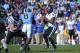 Nov 30, 2013; Chapel Hill, NC, USA; Duke Blue Devils quarterback Anthony Boone (7) looks to pass as North Carolina Tar Heels linebacker Norkeithus Otis (8) defends in the second quarter at Kenan Memorial Stadium. Mandatory Credit: Bob Donnan-USA TODAY Sp
