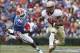 Nov 30, 2013; Gainesville, FL, USA; Florida State Seminoles running back Devonta Freeman (8) runs past Florida Gators linebacker Jarrad Davis (40) during the first quarter at Ben Hill Griffin Stadium. Mandatory Credit: Kim Klement-USA TODAY Sports