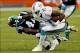 Nov 24, 2013; Miami Gardens, FL, USA; Miami Dolphins wide receiver Mike Wallace (11) stiff arms Carolina Panthers cornerback Captain Munnerlyn (41) in the second half of a game at Sun Life Stadium. The Panthers won 20-16. Mandatory Credit: Robert Mayer-US