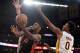 LOS ANGELES, CA - DECEMBER 08: Amir Johnson #15 of the Toronto Raptors scores on a layup past Nick Young #0 of the Los Angeles Lakers at Staples Center on December 8, 2013 in Los Angeles, California. NOTE TO USER: User expressly acknowledges and agrees
