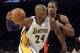 Dec 8, 2013; Los Angeles, CA, USA; Los Angeles Lakers shooting guard Kobe Bryant (24) drives to the basket against Toronto Raptors shooting guard DeMar DeRozan (10) during the second half at Staples Center. Mandatory Credit: Richard Mackson-USA TODAY Spor