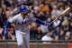 SAN FRANCISCO, CA - SEPTEMBER 24: Matt Kemp #27 of the Los Angeles Dodgers swings and watches the flight of his ball as he hits a solo home run during the sixth inning against the San Francisco Giants at AT&T Park on September 24, 2013 in San Francisco,