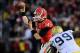 Nov 30, 2013; Atlanta, GA, USA; Georgia Bulldogs quarterback Hutson Mason (14) releases a pass under pressure from Georgia Tech Yellow Jackets defensive tackle Euclid Cummings (99) during the second half at Bobby Dodd Stadium. Georgia defeated Georgia Tec