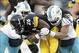 Dec 8, 2013; Pittsburgh, PA, USA; Pittsburgh Steelers running back Le'Veon Bell (26) rushes the ball as Miami Dolphins strong safety Chris Clemons (left) and outside linebacker Philip Wheeler (52) defend during the third quarter at Heinz Field. The Miami
