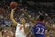 Dec 10, 2013; Gainesville, FL, USA; Florida Gators guard Scottie Wilbekin (5) shoots as Kansas Jayhawks guard Andrew Wiggins (22) defends during the first half at Stephen C. O'Connell Center. Mandatory Credit: Kim Klement-USA TODAY Sports