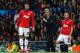 MANCHESTER, ENGLAND - DECEMBER 10: Robin van Persie (L) and Tom Cleverley of Manchester United prepare to come on as substitutes as Manager David Moyes looks on during the UEFA Champions League Group A match between Manchester United and Shakhtar Donets