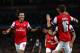 LONDON, ENGLAND - OCTOBER 01: Mesut Oezil #11of Arsenal is congratulated by teammate Aaron Ramsey #16 after scoring the opening goal during UEFA Champions League Group F match between Arsenal FC and SSC Napoli at Emirates Stadium on October 1, 2013 in L