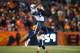 DENVER, CO - DECEMBER 8: Wide receiver Justin Hunter #15 of the Tennessee Titans has a fourth quarter catch but is quickly tackled by cornerback Kayvon Webster #36 of the Denver Broncos during a game at Sports Authority Field Field at Mile High on Decemb