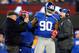 EAST RUTHERFORD, NJ - NOVEMBER 25: Head coach Tom Coughlin of the New York Giants and members of their staff help defensive end Jason Pierre-Paul #90 off the field after he was shaken up on a play against the Green Bay Packers at MetLife Stadium on Novem