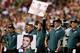 LANDOVER, MD - SEPTEMBER 09: Philadelphia Eagles coaches hold up Rocky and Elvis signs in the second quarter while taking on the Washington Redskins at FedExField on September 9, 2013 in Landover, Maryland. (Photo by Rob Carr/Getty Images)