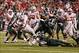 Dec 7, 2013; Indianapolis, IN, USA; Ohio State Buckeyes running back Carlos Hyde (34) is tackled by Michigan State Spartans safety Isaiah Lewis (9) during the Big Ten Championship game at Lucas Oil Stadium. Mandatory Credit: Brian Spurlock-USA TODAY Sport