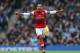MANCHESTER, ENGLAND - DECEMBER 14: Theo Walcott of Arsenal celebrates after scoring his first goal during the Barclays Premier League match between Manchester City and Arsenal at Etihad Stadium on December 14, 2013 in Manchester, England. (Photo by Cli