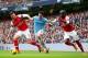 MANCHESTER, ENGLAND - DECEMBER 14: Samir Nasri of Manchester City is marshalled by Olivier Giroud and Bacary Sagna of Arsenal during the Barclays Premier League match between Manchester City and Arsenal at Etihad Stadium on December 14, 2013 in Manchester