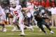 INDIANAPOLIS, IN - DECEMBER 07: Quarterback Braxton Miller #5 of the Ohio State Buckeyes moves away from the pressure of Darien Harris #45 of the Michigan State Spartans during the Big Ten Conference Championship game at Lucas Oil Stadium on December 7,