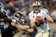 ST. LOUIS, MO - DECEMBER 15: Drew Brees #9 of the New Orleans Saints is pressured in the second quarter against the St. Louis Rams at the Edward Jones Dome on December 15, 2013 in St. Louis, Missouri. (Photo by Michael Thomas/Getty Images)
