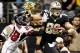 November 11, 2012; New Orleans, LA, USA; New Orleans Saints tight end Jimmy Graham (80) stiff arms Atlanta Falcons free safety Thomas DeCoud (28) during the fourth quarter of a game at the Mercedes-Benz Superdome. The Saints defeated the Falcons 31-27. Ma