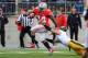 COLUMBUS, OH - OCTOBER 19: Carlos Hyde #34 of the Ohio State Buckeyes breaks a tackle attempt from Tanner Miller #5 of the Iowa Hawkeyes on his way to a 19-yard touchdown run in the fourth quarter at Ohio Stadium on October 19, 2013 in Columbus, Ohio. Oh
