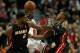CHICAGO, IL - DECEMBER 05: LeBron James #6 of the Miami Heat fouls Loul Deng #9 of the Chicago Bulls as Mario Chalmers #15 defends at the United Center on December 5, 2013 in Chicago, Illinois. NOTE TO USER: User expressly acknowledges and agrees that, b