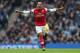 MANCHESTER, ENGLAND - DECEMBER 14: Theo Walcott of Arsenal celebrates after scoring his first goal during the Barclays Premier League match between Manchester City and Arsenal at Etihad Stadium on December 14, 2013 in Manchester, England. (Photo by Cli
