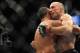 Nov 16, 2013; Las Vegas, NV, USA; Georges St-Pierre (red gloves) and Johny Hendricks (blue gloves) hug after their welterweight championship bout during UFC 167 at MGM Grand Garden Arena. Mandatory Credit: Stephen R. Sylvanie-USA TODAY Sports