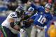 EAST RUTHERFORD, NJ - DECEMBER 15: Quarterback Eli Manning #10 of the New York Giants is hit as he throws a pass in the 1st half against the Seattle Seahawks at MetLife Stadium on December 15, 2013 in East Rutherford, New Jersey. (Photo by Ron Antonelli/
