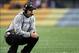 Oct 20, 2013; Pittsburgh, PA, USA; Baltimore Ravens head coach John Harbaugh squats on the sidelines against the Pittsburgh Steelers during the second half at Heinz Field. The Steelers won the game, 19-16. Mandatory Credit: Jason Bridge-USA TODAY Sports