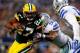 ARLINGTON, TX - DECEMBER 15: Running back Eddie Lacy #27 of the Green Bay Packers runs with the ball as defensive end George Selvie #99 of the Dallas Cowboys defends during a game at AT&T Stadium on December 15, 2013 in Arlington, Texas. (Photo by Tom P
