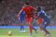 LIVERPOOL, ENGLAND - DECEMBER 21: Luis Suarez of Liverpool attempts to move away from Kevin Theophile of Cardiff City during the Barclays Premier League match between Liverpool and Cardiff City at Anfield at Anfield on December 21, 2013 in Liverpool, Eng