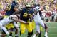 ANN ARBOR, MI - AUGUST 31: Derrick Green #27 of the Michigan Wolverines tries to avoid the tackle of Cody Lopez #51 of the Central Michigan Chippewas at Michigan Stadium on August 31, 2013 in Ann Arbor, Michigan. Michigan won the 59-9. (Photo by Gregory S