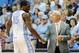 LAS VEGAS, NV - NOVEMBER 25: Head coach Roy Williams of the North Carolina Tar Heels shakes hands with P.J. Hairston #15 as he comes out of the game against the South Carolina Gamecocks during the third round of the Continental Tire Las Vegas Invitationa