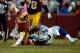 LANDOVER, MD - DECEMBER 22: Quarterback Kirk Cousins #12 of the Washington Redskins is tackled by DeMarcus Ware #94 of the Dallas Cowboys in the second half during an NFL game at FedExField on December 22, 2013 in Landover, Maryland. (Photo by Patrick M