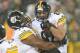 GREEN BAY, WI - DECEMBER 22: Matt Spaeth #87 of the Pittsburgh Steelers is lifted up in the air by teammate Marcus Gilbert #77 after catching a touchdown pass against the Green Bay Packers at Lambeau Field on December 22, 2013 in Green Bay, Wisconsin. The