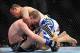 Feb 2, 2013; Las Vegas, NV, USA; Gleison Tibau (top) attempts a guillotine choke on Evan Dunham (bottom) during UFC 156 at the Mandalay Bay Events Center. Mandatory Credit: Gary A. Vasquez-USA TODAY Sports