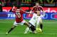 Nainggolan with one of his signature slides in a match against Milan