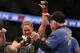 ANAHEIM, CA - FEBRUARY 23: Ronda Rousey celebrates her UFC Bantamweight Title over Liz Carmouche with a member of her team during UFC 157 at Honda Center on February 23, 2013 in Anaheim, California. (Photo by Jeff Gross/Getty Images)