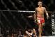 Dec 28, 2013; Las Vegas, NV, USA; Dustin Poirier (red gloves) reacts after knocking down Diego Brandao (blue gloves) during their UFC middleweight bout at the MGM Grand Garden Arena. Mandatory Credit: Jayne Kamin-Oncea-USA TODAY Sports