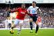 LONDON, ENGLAND - DECEMBER 01: Wayne Rooney of Manchester United and Vlad Chiriches of Tottenham Hotspur compete for the ball during the Barclays Premier League Match between Tottenham Hotspur and Manchester United at White Hart Lane on December 1, 2013