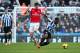 NEWCASTLE UPON TYNE, ENGLAND - DECEMBER 29: Olivier Giroud of Arsenal challenges Vurnon Anita of Newcastle United during the Barclays Premier League match between Newcastle United and Arsenal at St James' Park on December 29, 2013 in Newcastle upon Tyne,