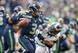 SEATTLE, WA - DECEMBER 29: Quarterback Russell Wilson #3 of the Seattle Seahawks passes under pressure from linebacker Alec Ogletree #52 of the St. Louis Rams at CenturyLink Field on December 29, 2013 in Seattle, Washington. The Seahawks defeated the Ram