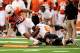 AUSTIN, TX - NOVEMBER 16: Sam Wren #89 of the Oklahoma State Cowboys tackles Malcolm Brown #28 of the Texas Longhorns during a game at Darrell K Royal-Texas Memorial Stadium on November 16, 2013 in Austin, Texas. Oklahoma State won the game 38-13. (Pho