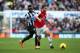 NEWCASTLE UPON TYNE, ENGLAND - DECEMBER 29: Mathieu Flamini of Arsenal is closed down by Cheick Tiote of Newcastle United during the Barclays Premier League match between Newcastle United and Arsenal at St James' Park on December 29, 2013 in Newcastle up