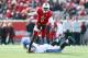 LOUISVILLE, KY - NOVEMBER 23: Teddy Bridgewater #5 of the Louisville Cardinals avoids the tackle of Chase Rome #47 of the Memphis Tigers at Papa John's Cardinal Stadium on November 23, 2013 in Louisville, Kentucky. (Photo by Andy Lyons/Getty Images)