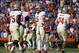 Nov 30, 2013; Gainesville, FL, USA; Florida State Seminoles quarterback Jameis Winston (5) high fives teammates after they scored against the Florida Gators during the second half at Ben Hill Griffin Stadium. Florida State Seminoles defeated the Florida G