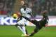 SWANSEA, WALES - JANUARY 01: Roland Lamah (L) of Swansea City watches Fernandinho (R) of Manchester City during the Barclays Premier League match between Swansea City and Manchester City at the Liberty Stadium on January 1, 2014 in Swansea, Wales. (Phot